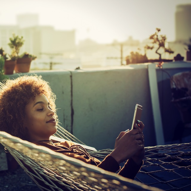 Girl in hammock with phone